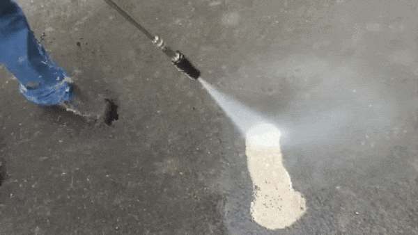 Garden hose attachment cleaning a concrete driveway